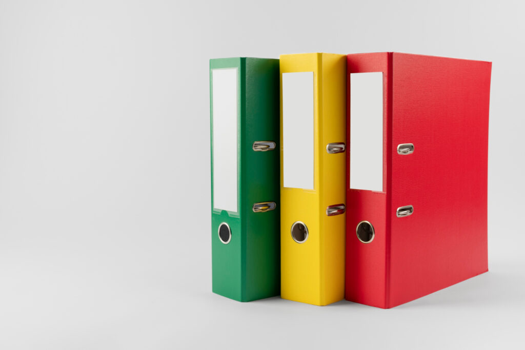 Three colorful office binders illustrating a summary of adjudication rules under the Indian Patent Act.