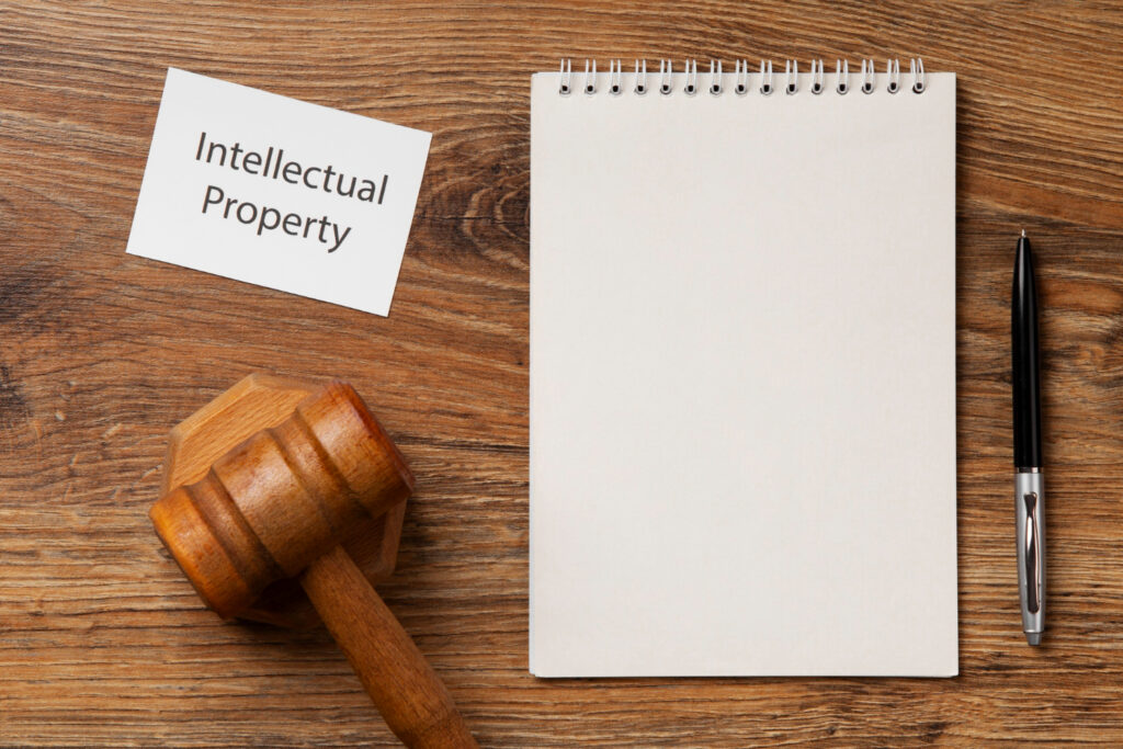 Notebook, gavel, and "Intellectual Property" card representing India's Patent Rules evolution.